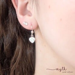 Sterling silver shiva shell heart earrings modelled by Courtney