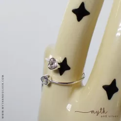 Adjustable double heart ring shown on ceramic hand